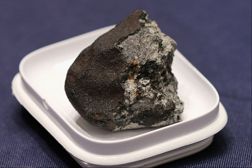 WASHINGTON, DC - JUNE 17: A piece of the Chelyabinsk meteorite is displayed before a hearing of the House istration Committee in the Longworth House Office Building on Capitol Hill June 17, 2015 in Washington, DC. Famously caught by a number of video cameras, the meteorite fell to earth February 15, 2013 and caused a large amount of damage in the city of Chelyabinsk, Russia. (Photo by Chip Somodevilla/Getty Images)